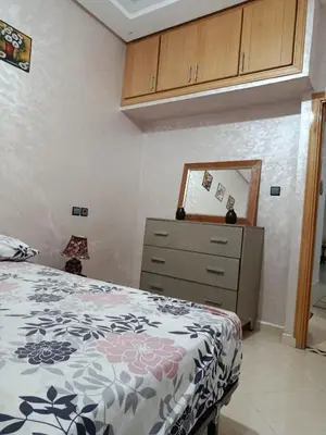 a bedroom with a bed and a dresser and a mirror at Dar araha in Fès