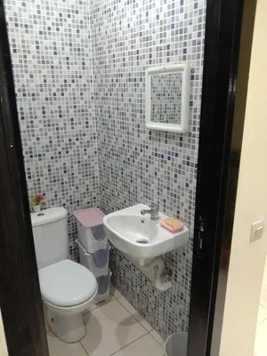 a small bathroom with a toilet and a sink at إقامة النور الصخيرات in Oulad Akkou
