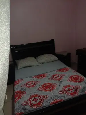 a bedroom with a bed with a blanket on it at إقامة النور الصخيرات in Oulad Akkou