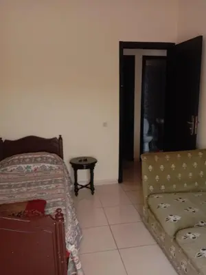 a living room with a couch and a table at إقامة النور الصخيرات in Oulad Akkou