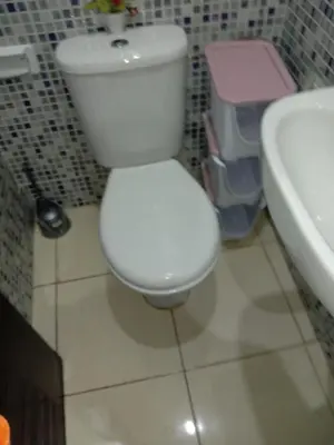 a bathroom with a white toilet and a sink at إقامة النور الصخيرات in Oulad Akkou