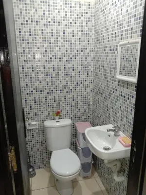 a bathroom with a toilet and a sink at إقامة النور الصخيرات in Oulad Akkou