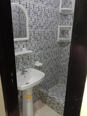 a bathroom with a sink and a shower at إقامة النور الصخيرات in Oulad Akkou
