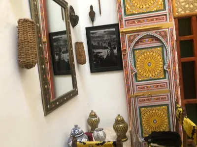 a mirror and some pictures on a wall at Reggae Riad in Fès