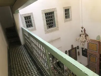 a stairway with two windows and a stair case at Reggae Riad in Fès