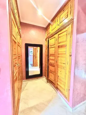 a room with two wooden doors and a window at Villa H in Oulad Snaguia