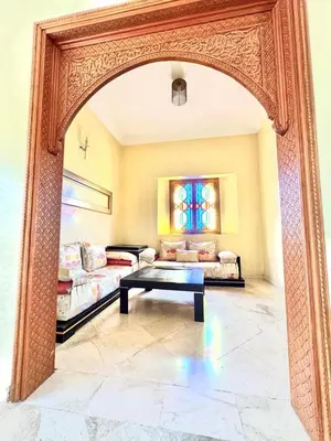 an archway in a room with a couch and a table at Villa H in Oulad Snaguia
