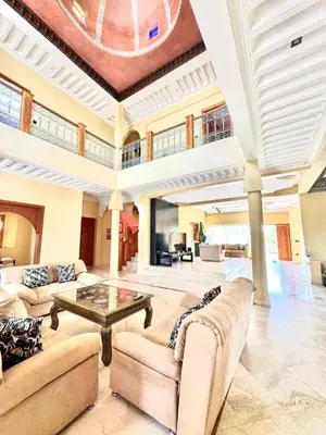 a large living room with couches and a table at Villa H in Oulad Snaguia