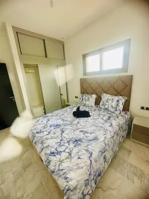 a cat laying on a bed in a bedroom at Villa Itran Marrakech in Aguelmous