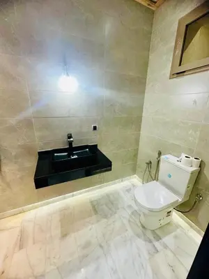a bathroom with a toilet and a sink at Villa Itran Marrakech in Aguelmous