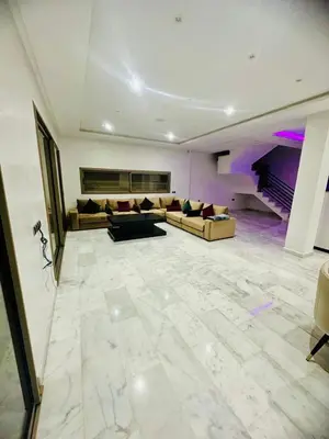 a large living room with couches and a piano at Villa Itran Marrakech in Aguelmous
