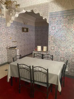 a dining room with a table and two chairs at Azrou in Azrou