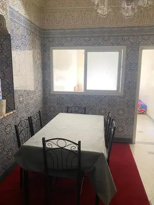 a dining room with a table and a window at Azrou in Azrou