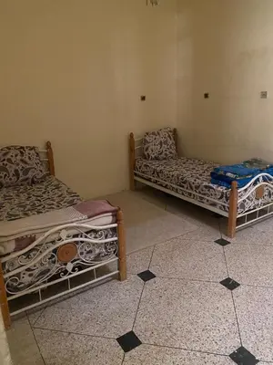 a room with two beds in a room at Azrou in Azrou