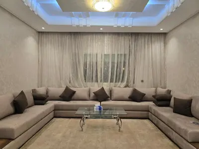 a living room with a couch and a table at belle vue à petit prix in Meknès