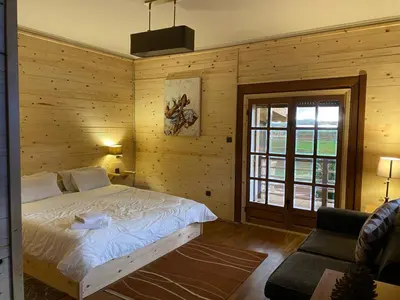 a bedroom with a bed in a wooden wall at Rise In Valley in Ifrane