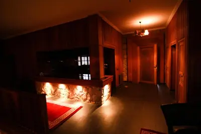a living room with a fireplace with a television on it at Rise In Valley in Ifrane