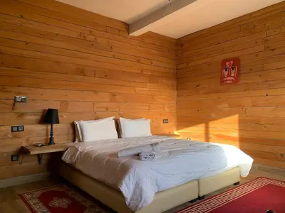 a bedroom with a bed in a wooden wall at Rise In Valley in Ifrane