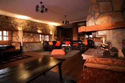 a large living room with a stone wall at Rise In Valley in Ifrane