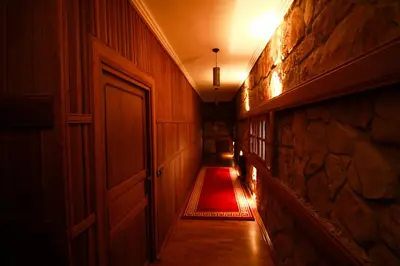 an empty hallway with a door and a red carpet at Rise In Valley in Ifrane