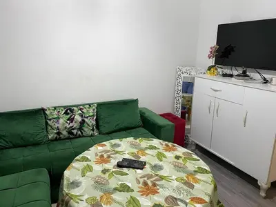a living room with a green couch and a table at Dar Tranquila in Fès