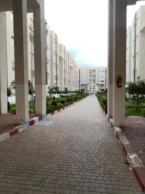 an empty street in a city with tall buildings at Dar Tranquila in Fès