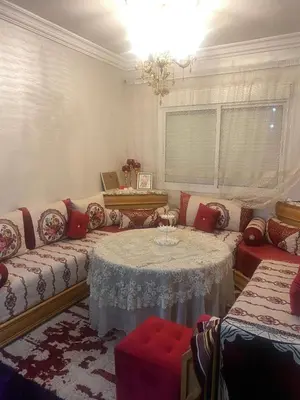 a living room with a table and a couch at Dar Tranquila in Fès