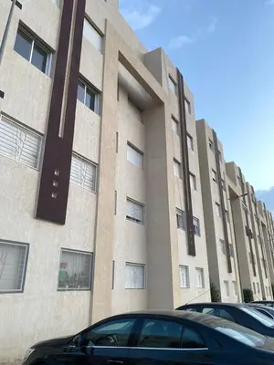 a large building with cars parked in front of it at Dar Tranquila in Fès