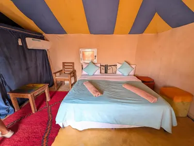 a bedroom with a bed in a tent at Luxury Desert Camp with AC & Heating in Merzouga in Lac Yasmins