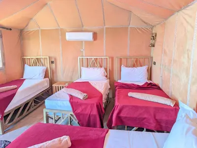 a room with two beds in a tent at Luxury Desert Camp with AC & Heating in Merzouga in Lac Yasmins