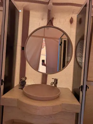 a bathroom with a sink and a mirror at Luxury Desert Camp with AC & Heating in Merzouga in Lac Yasmins