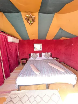 a bedroom with two beds in a tent at Luxury Desert Camp with AC & Heating in Merzouga in Lac Yasmins