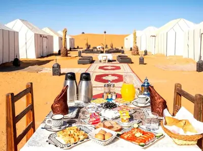 a table with food on it in the desert at Fatima Luxury desert camp in Merzouga