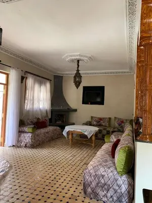 a living room with a couch and a table at Villa d'Exception à Ourika Nichée au Cœur des Montagnes in Aghbalou