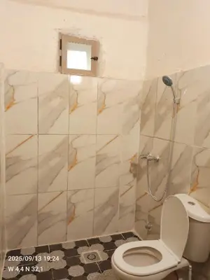 a bathroom with a toilet and a shower at Gîte Palma Eagle Ziz Canyon in Er Rachidia