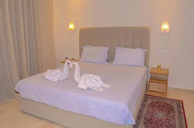two swans are sitting on top of a bed at Perfect Stop in Midelt in Midelt