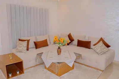 a living room with a white couch and a table at Perfect Stop in Midelt in Midelt