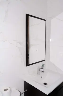 a white bathroom with a sink and a mirror at Perfect Stop in Midelt in Midelt