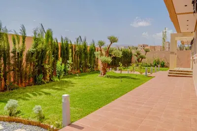 a garden with a brick walkway and plants at Perfect Stop in Midelt in Midelt