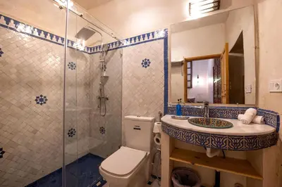 a bathroom with a toilet and a sink and a shower at Riad Dar Sira in Fès