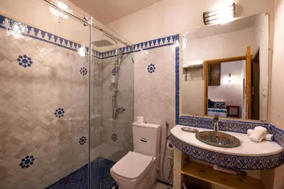 a bathroom with a shower and a toilet and a sink at Riad Dar Sira in Fès