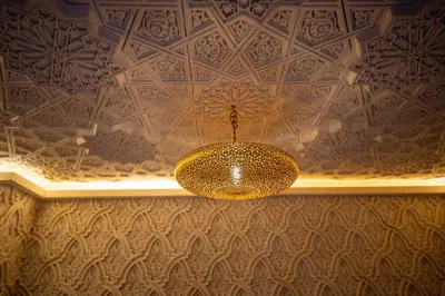 a chandelier hanging from a ceiling in a room at Riad Dar Sira in Fès