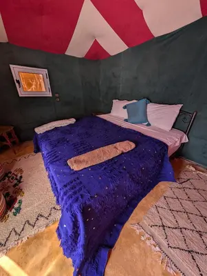 a bedroom with a bed in a tent at Air Conditioning Berber Desert Camp in Merzouga