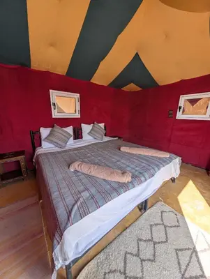 a bedroom with two beds in a tent at Air Conditioning Berber Desert Camp in Merzouga