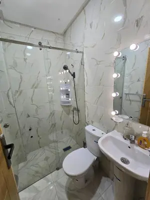 a bathroom with a shower and a toilet and a sink at IM Location Euromed Fès in Fès