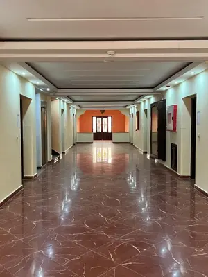 an empty hallway in a building with a tile floor at Hotel Ourida Zagora in Zagora
