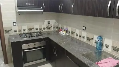 a kitchen with a stove and a counter top at Reda Ghazalie in Meknès