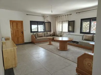 a living room with a table and a couch at Apartement khadija in Azrou