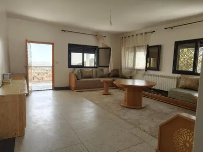 a living room with a table and a couch at Apartement khadija in Azrou