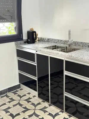 a kitchen with a counter top and a sink at Apartement khadija in Azrou